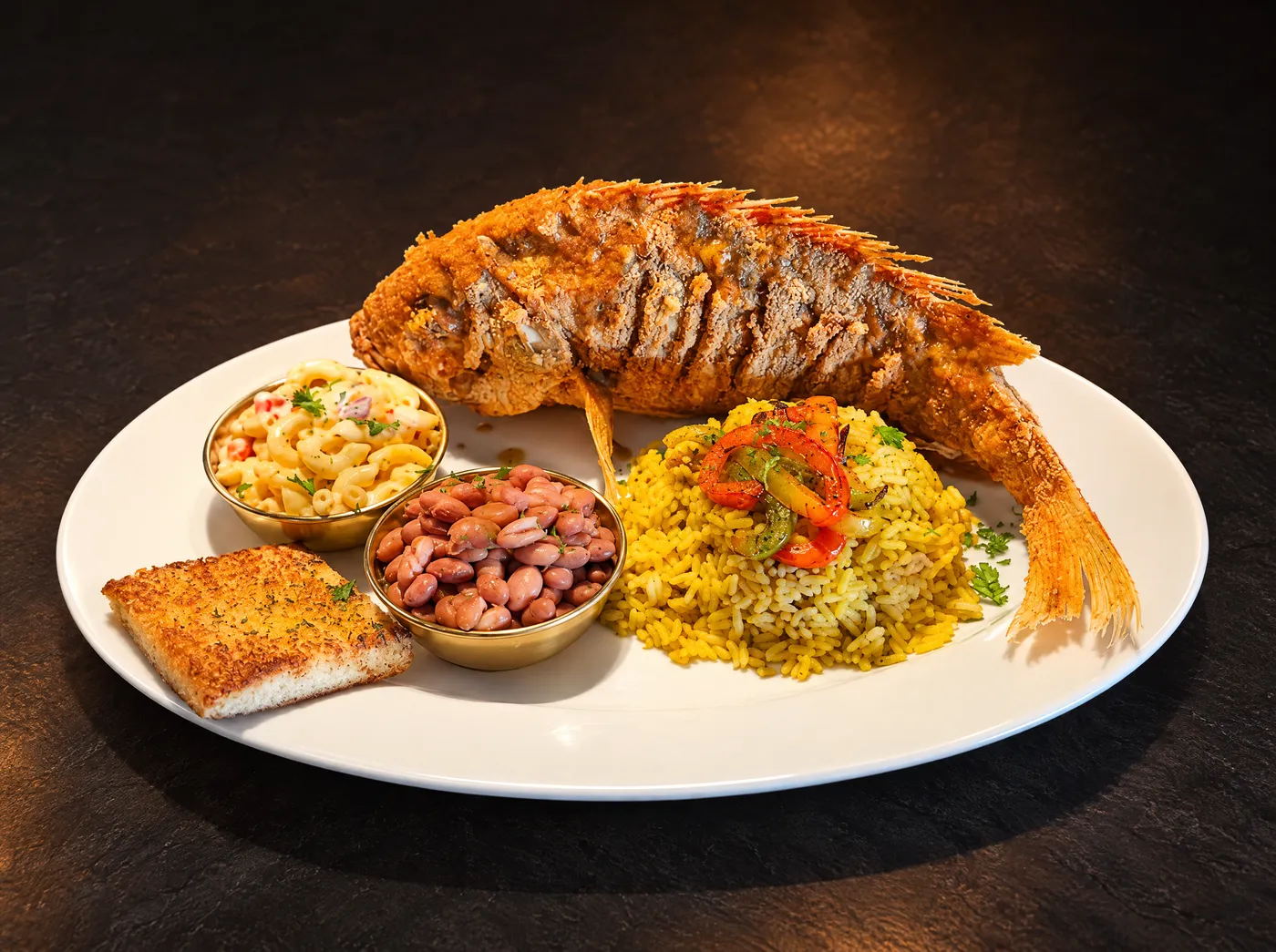 Whole fried red snapper with golden rice, mac and cheese, beans and garlic toast